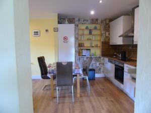a kitchen with a table and chairs in a room at Ferienwohnung Csilla 2 in Oberweid