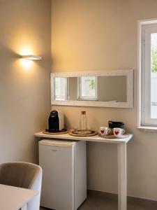 a small kitchen with a table with two cups on it at Dimora del tramonto in Trani