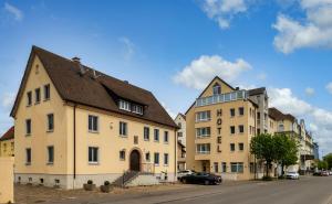 a couple of buildings on a street with a car at Hotel Zur Schmiede in Radolfzell am Bodensee