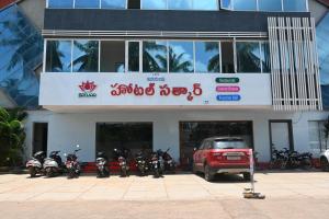 a group of motorcycles parked in front of a building at Hotel Satkar in Amalāpuram