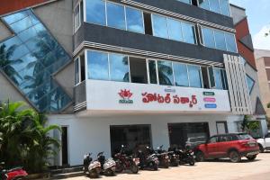 a building with motorcycles parked in front of it at Hotel Satkar in Amalāpuram