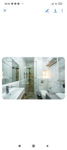 a bathroom with two sinks and a mirror at Gori Apartaments in Gori