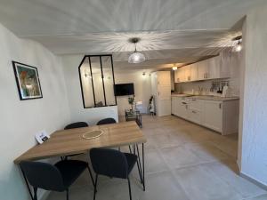 a kitchen and dining room with a table and chairs at La maison jaune in Roquebrune-Cap-Martin