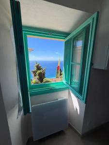 a window in a room with a view of the ocean at La maison jaune in Roquebrune-Cap-Martin