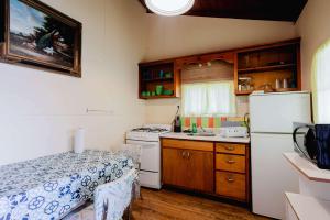 a small kitchen with a refrigerator and a sink at Ambleside - 2-Bedroom Cottage #4 in Kawartha Lakes