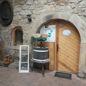 a wooden garage door with a chair in front of it at Ferienweingut Schäfer in Niedersteinbach