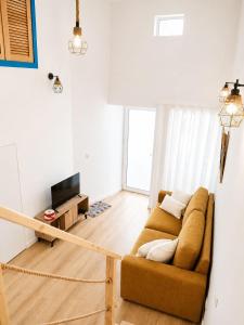 a living room with a couch and a tv at Casa Trainêra in Nazaré