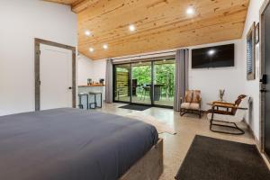 a bedroom with a bed and a sliding glass door at Standing Rock Farms in Madison