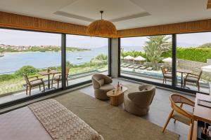 a living room with a view of the ocean at Cesme Sarezya Luxury Boutique Hotel in Çeşme