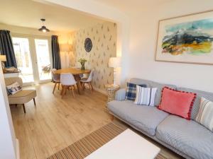 a living room with a couch and a table at Dunford Cottage in Bamburgh
