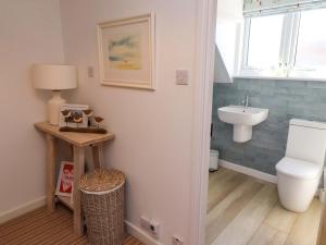 a bathroom with a toilet and a sink at Dunford Cottage in Bamburgh +52 photos