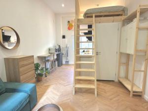 a living room with bunk beds and a kitchen at Le Perchoir in Beauregard