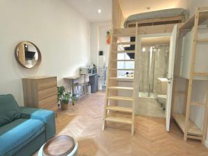 a living room with a couch and bunk beds at Le Perchoir in Beauregard +3 photos