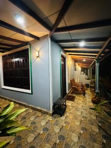 a room with a blue wall and a patio at The Sigiriya Rock Gate Chalet in Sigiriya