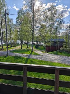 a view of a park from a balcony at Mökki upealla maisemalla in Kouvola