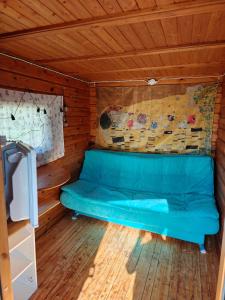 a blue couch in the inside of a cabin at Mökki upealla maisemalla in Kouvola