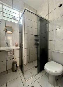a bathroom with a shower and a toilet and a sink at Kitnet Unip Mandic in Campinas