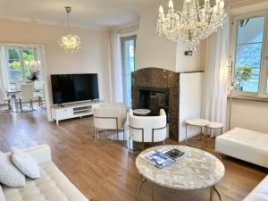 a living room with a couch and a fireplace at Villa Grande Dame by Fewotessin in Minusio
