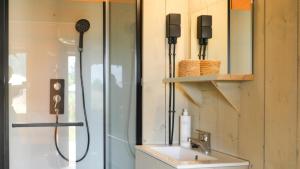 a bathroom with a shower with a sink and a shower at Fårup Skovbrynet in Saltum +35 photos