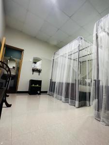 an empty room with curtains in a hospital room at The Sigiriya Rock Gate Chalet in Sigiriya