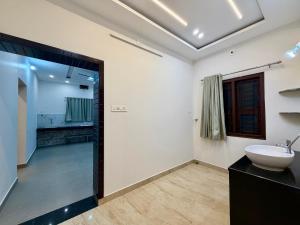 a bathroom with a sink and a mirror at Tri Riverfront Homestay in Udupi +18 photos