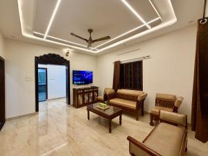 a living room with a couch and a table at Tri Riverfront Homestay in Udupi