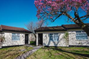 a house with a flowering tree in front of it at Park Hall Cottages ,Chorley, Preston,Lancashire in Chorley
