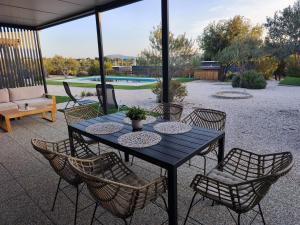a black table and chairs with a patio at Rilux Mobile Home "Camping Pirovac" in Pirovac