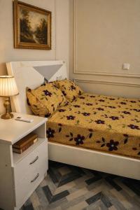 a bedroom with a bed and a nightstand with a lamp at CJ apartment kasoa in Kasoa