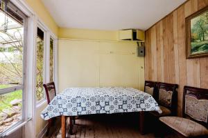 a dining room with a table and chairs and a window at 3-Bedroom Cottage #7 - Ambleside in Kawartha Lakes