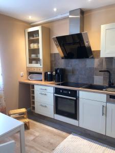 a kitchen with white cabinets and a stove top oven at Emmerglück Lügde in Lügde