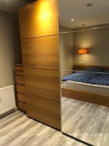 a bedroom with a bed and a large wooden closet at Emmerglück Lügde in Lügde