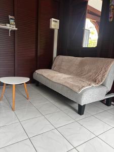 a bed and a table in a room at Cerise in Sainte-Anne