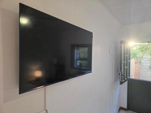 a large flat screen tv hanging on a wall at In Vrede in George