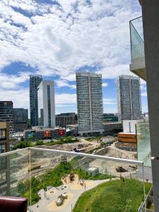 a view of a city skyline with tall buildings at SunsetSkylineApartment in Nivy