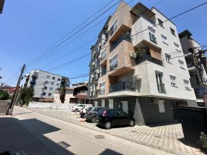 a building with cars parked in front of it at TULUM luxury suites-SKOPJE in Skopje