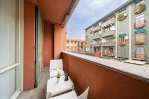 an apartment balcony with a view of a building at Lake Como - Front Station - Lake at 2 min - Wifi in Lecco
