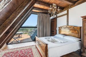 a bedroom with a bed and a large window at Sunrise House - Swimming Pool in Berat +67 photos