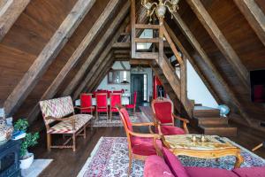 a living room with red chairs and a table at Sunrise House - Swimming Pool in Berat