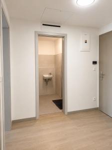 an empty room with a sink in a bathroom at SunsetSkylineApartment in Nivy +15 photos