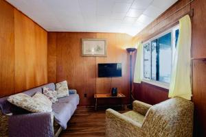a living room with a couch and two chairs at Ambleside - 2-Bedroom Cottage #8 in Kawartha Lakes