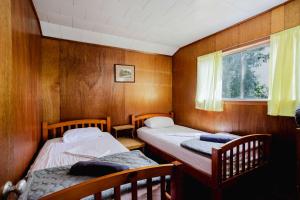 a room with two beds and a window at Ambleside - 2-Bedroom Cottage #8 in Kawartha Lakes