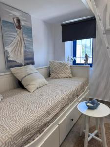 a small bed in a room with a window at Little Gem -A Cycladic Aura- Serifos in Serifos Chora