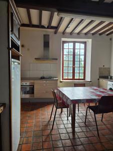a kitchen with a table and chairs in a room at Gîte VINCENT in Château-Salins