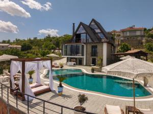 a swimming pool in front of a house at Sunrise House - Swimming Pool in Berat