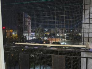 a window with a view of a city at night at Stayvora Nest in Bangalore