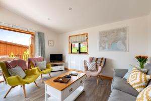 a living room with a couch and chairs and a table at L56 - Seaglass in Truro