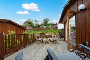 a wooden deck with a table and chairs on it at L56 - Seaglass in Truro