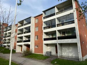 an empty apartment building with a red brick at Mirella in Tampere