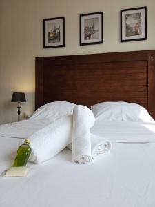 a bed with towels and a bottle of soap on it at Le 61 Roosvelt in Amiens